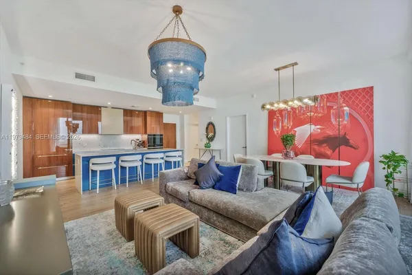 a living room with furniture a table and chairs