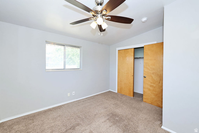 1272 Cook Street Ogden, UT 84404 - Photo 24 of 46 Room featuring light gray walls, brown carpet, ceiling fan with light fixture, sliding closet doors with wood-finish, and a window with white trim