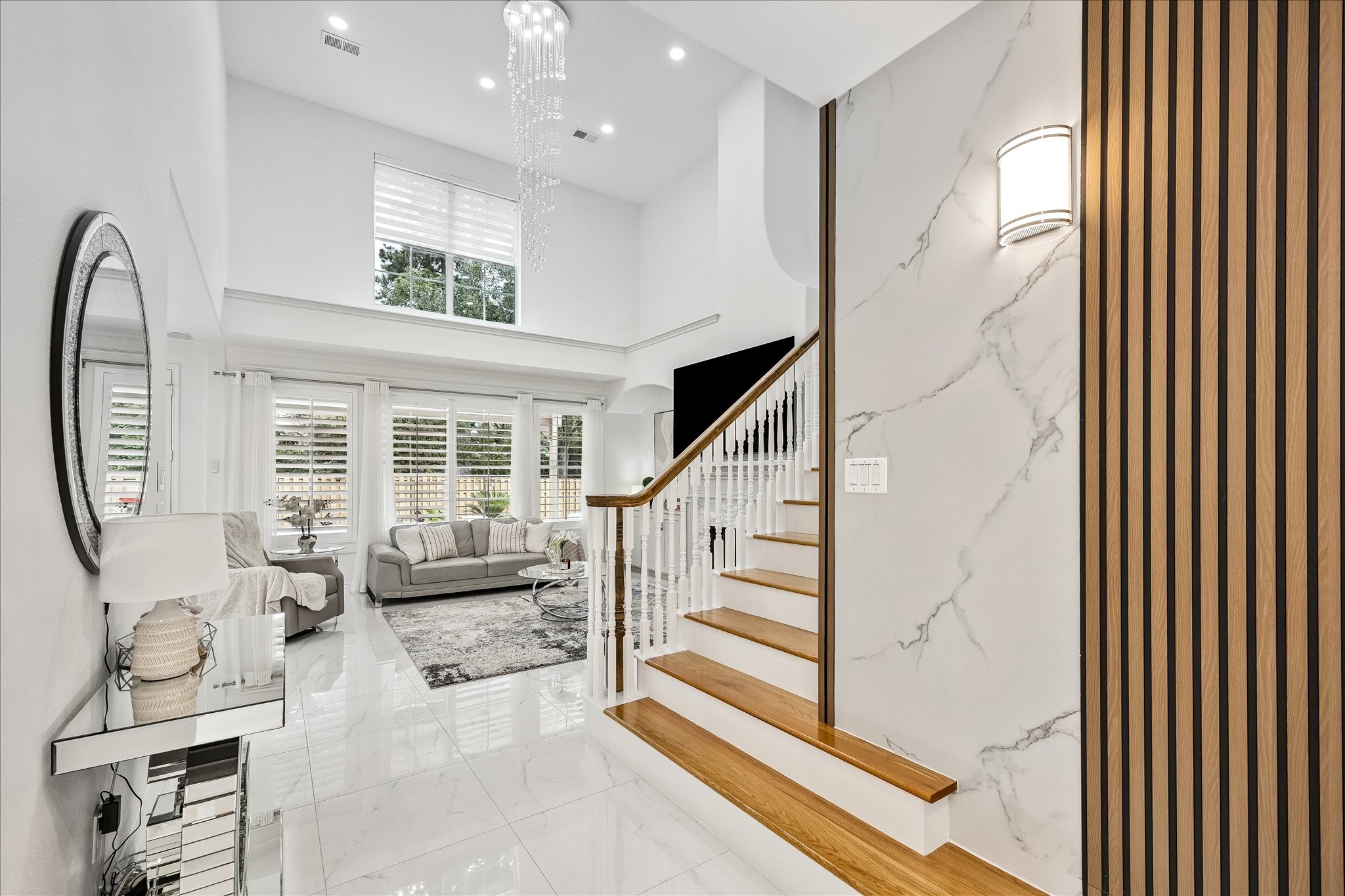 15 West Beckonvale Circle The Woodlands, TX 77382 - Photo 6 of 44 Beyond the entryway, the home opens up to a bright living room with soaring ceilings and a striking staircase featuring rich hardwood treads.