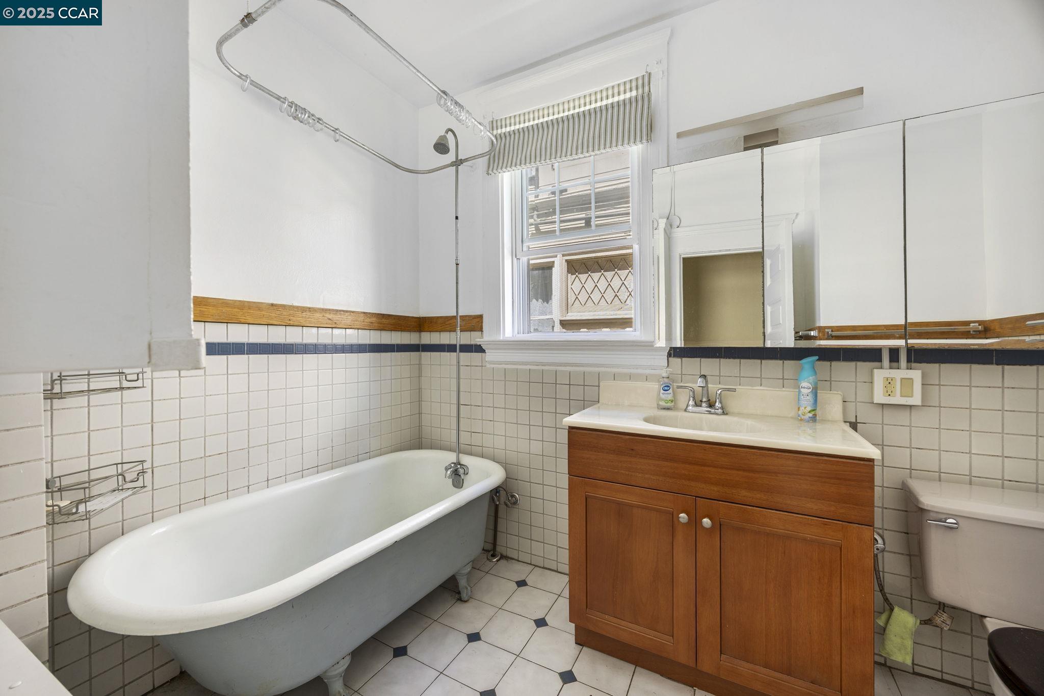 1220 Chestnut Street Alameda, CA 94501 - Photo 11 of 29 a bathroom with a tub sink toilet and mirror
