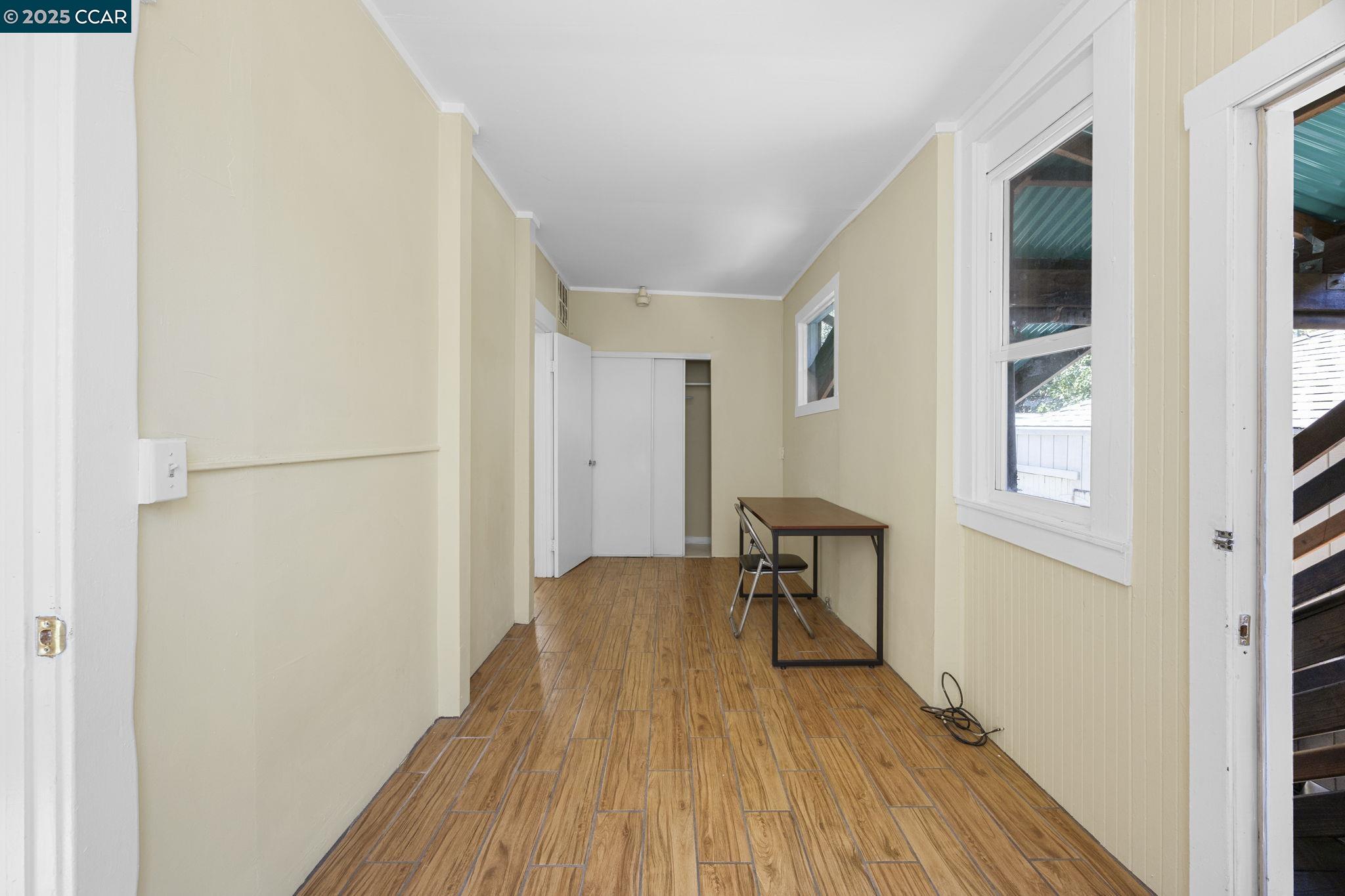 1220 Chestnut Street Alameda, CA 94501 - Photo 16 of 29 a view of a hallway with wooden floor and a bathroom