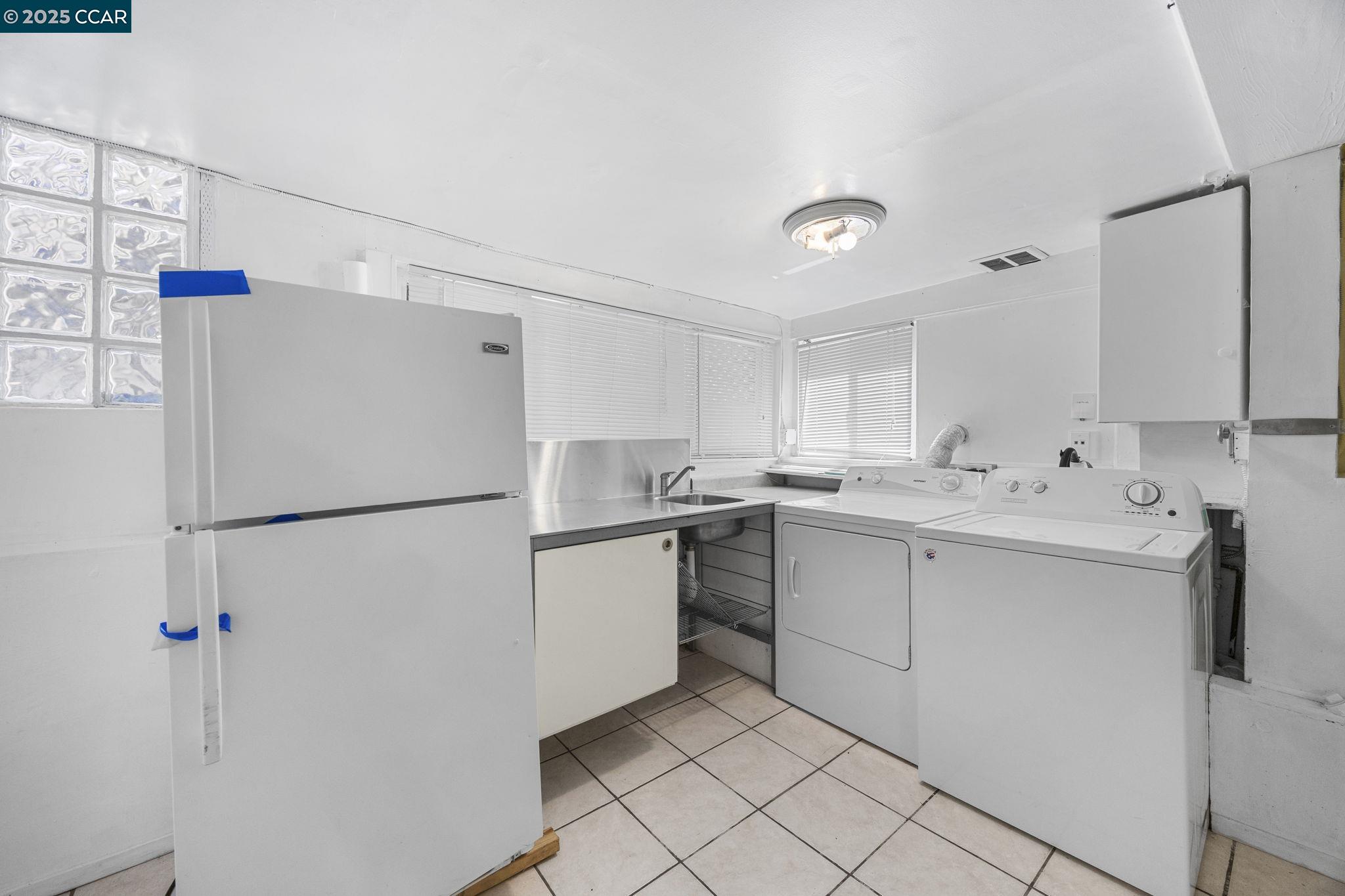 1220 Chestnut Street Alameda, CA 94501 - Photo 25 of 29 a white refrigerator freezer sitting inside of a kitchen