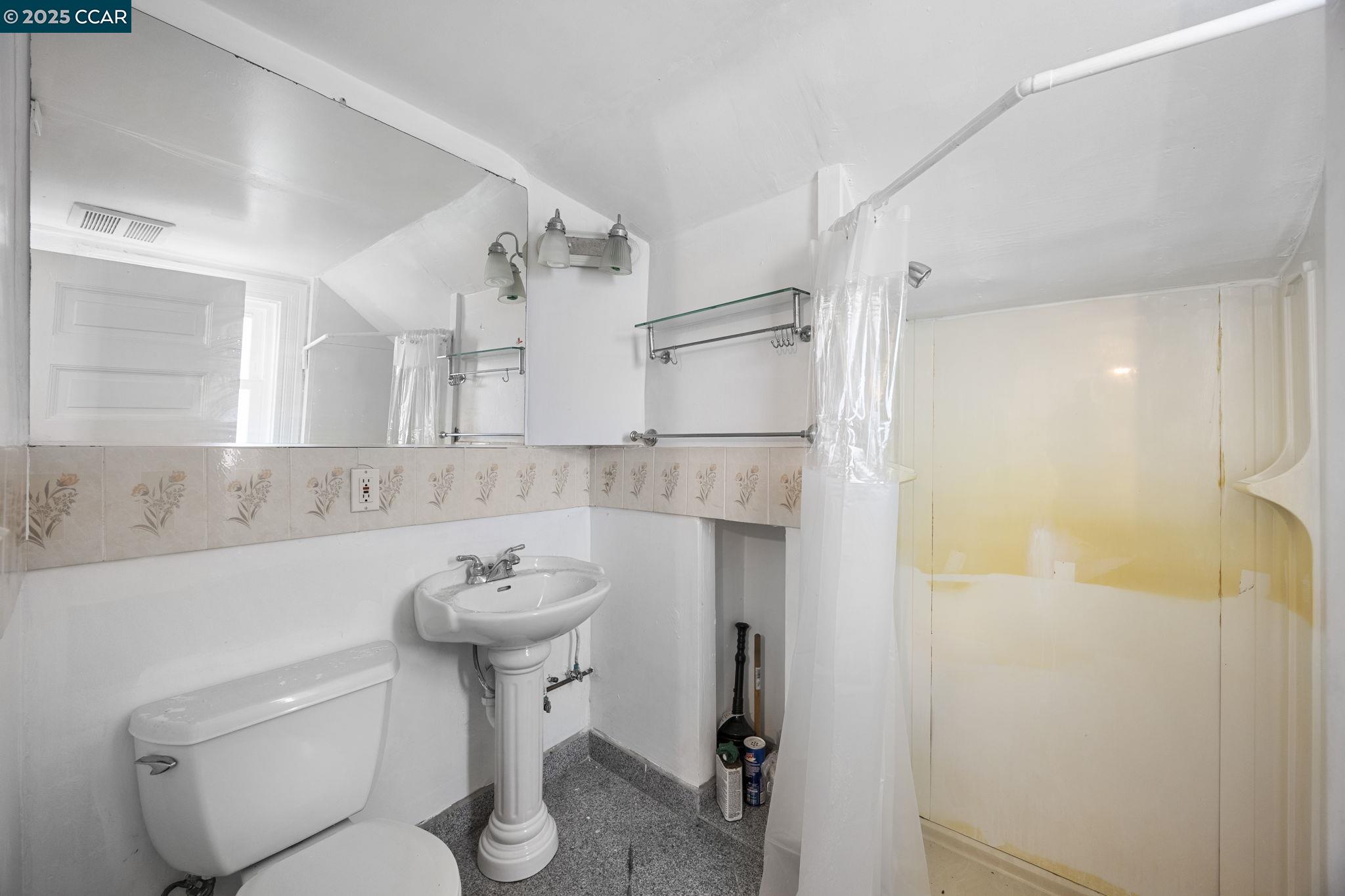 1220 Chestnut Street Alameda, CA 94501 - Photo 29 of 29 a bathroom with a sink toilet and a mirror