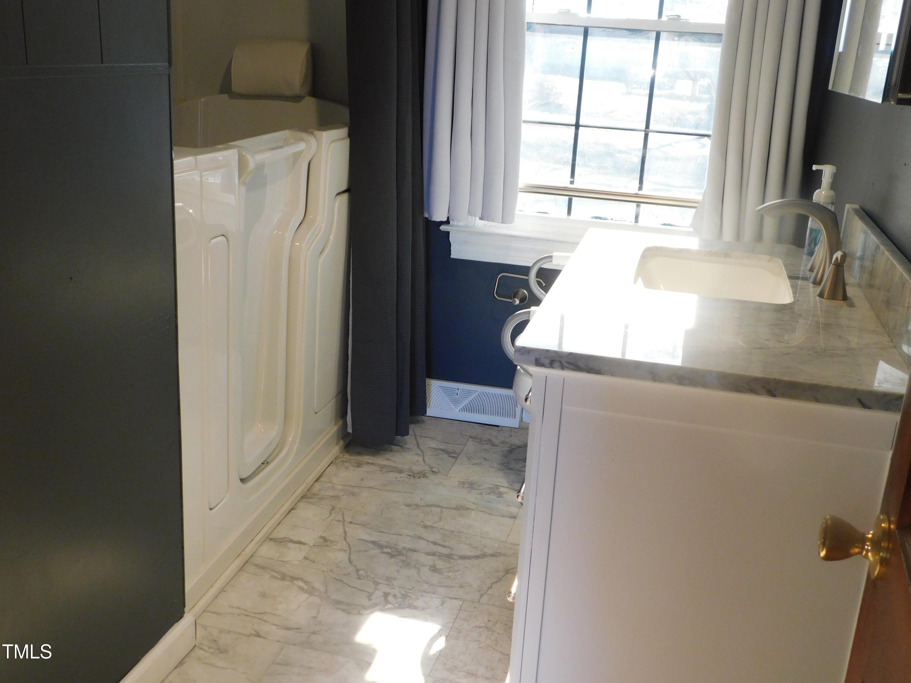 477 Providence Road Roxboro, NC 27573 - Photo 20 of 32 a bathroom with a granite countertop sink and a large mirror