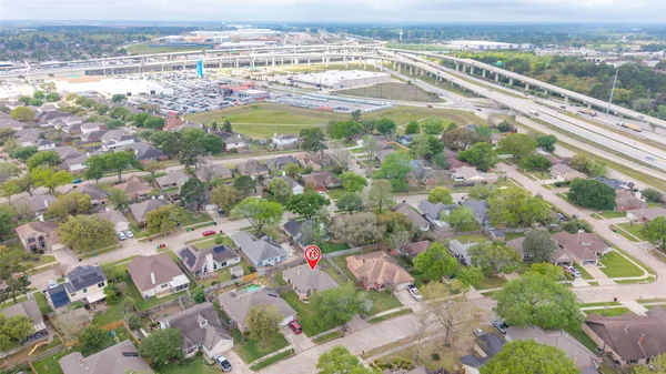 an aerial view of a residential houses with yard