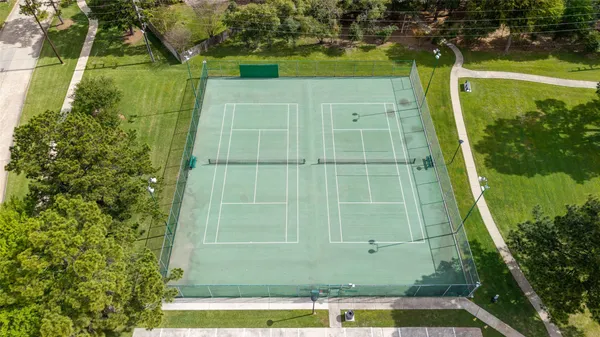 an aerial view of a house a yard and a swimming pool