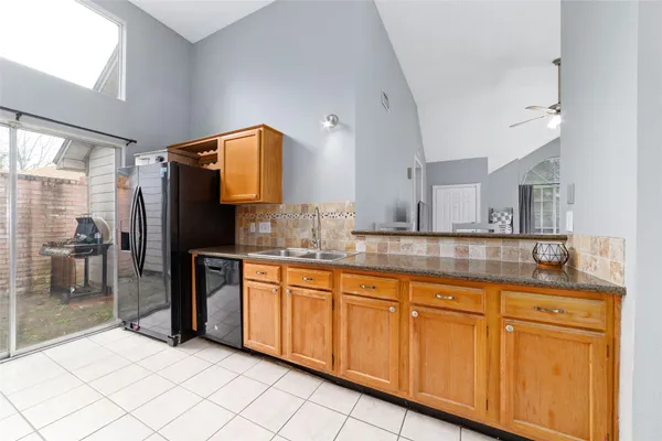 a kitchen with granite countertop a sink and cabinets