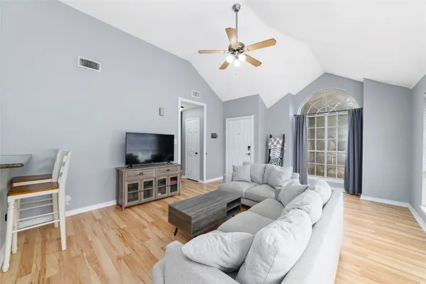a living room with furniture and a flat screen tv