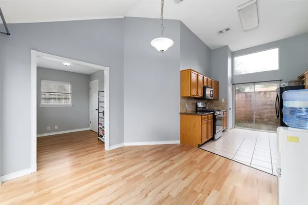 a view of a kitchen with a sink and dishwasher wooden floor