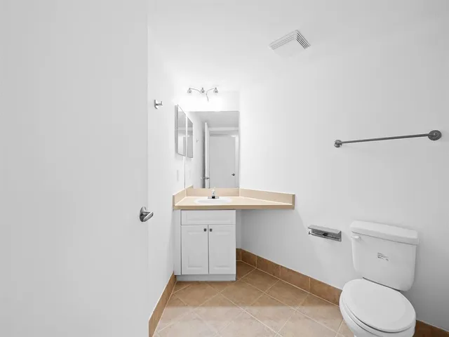 a bathroom with a sink a toilet and mirror