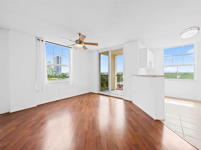 a view of a livingroom with wooden floor and a window