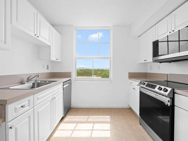 a kitchen with a sink stove and cabinets
