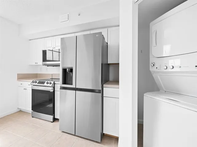 a kitchen with a refrigerator and a stove