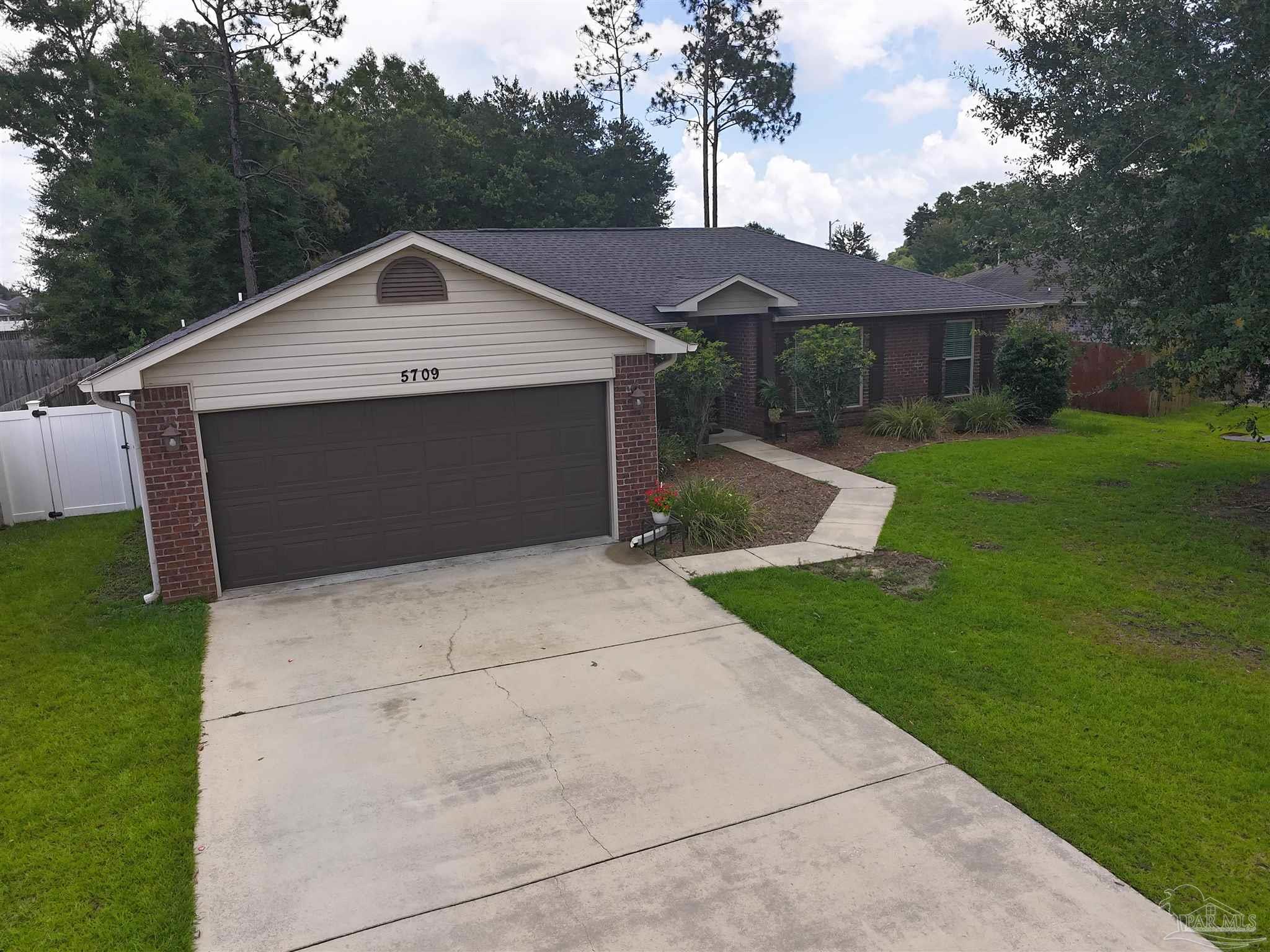 5709 Mill Stream Way Pace, FL 32571 - Photo 10 of 48 a front view of house with yard and green space