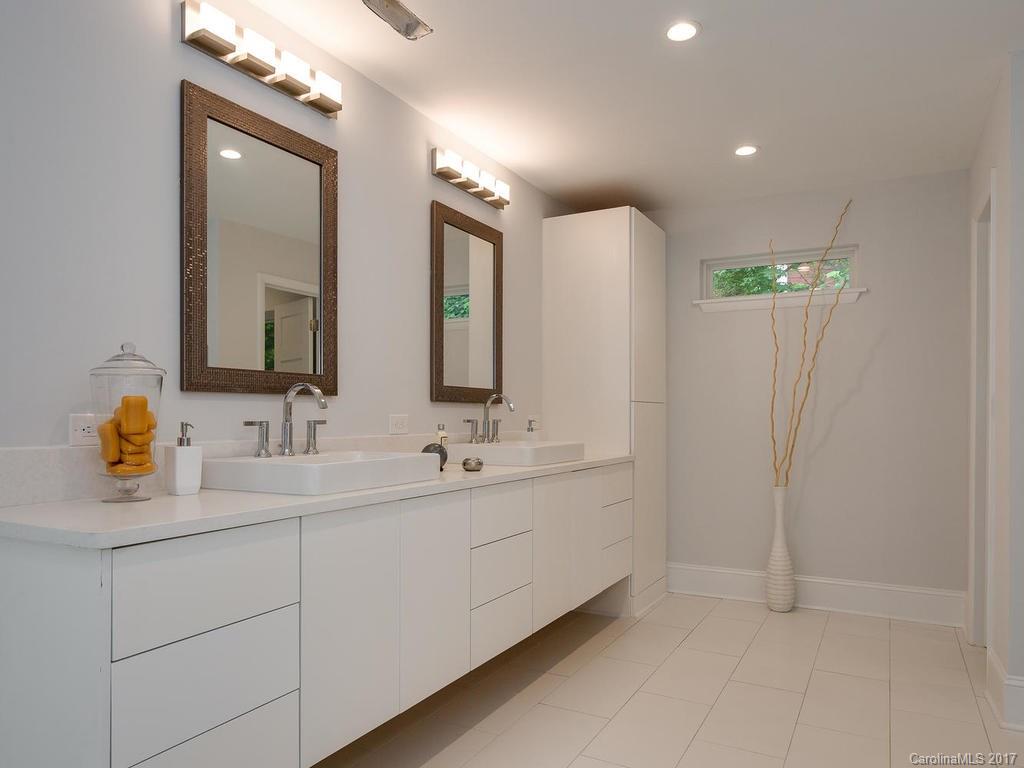 101 Heathwood Road Charlotte, NC 28211 - Photo 12 of 24 a bathroom with double vanity sinks and a mirror