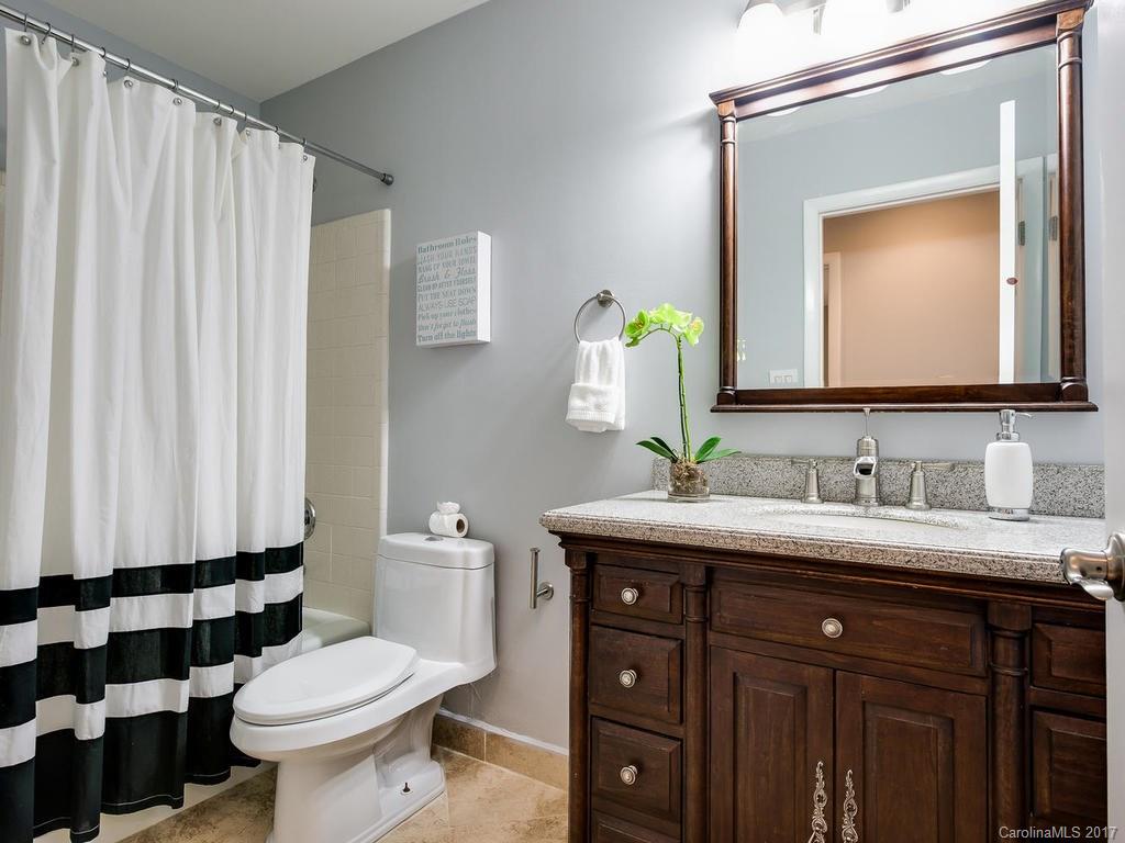 101 Heathwood Road Charlotte, NC 28211 - Photo 17 of 24 a bathroom with a granite countertop sink a toilet and a mirror