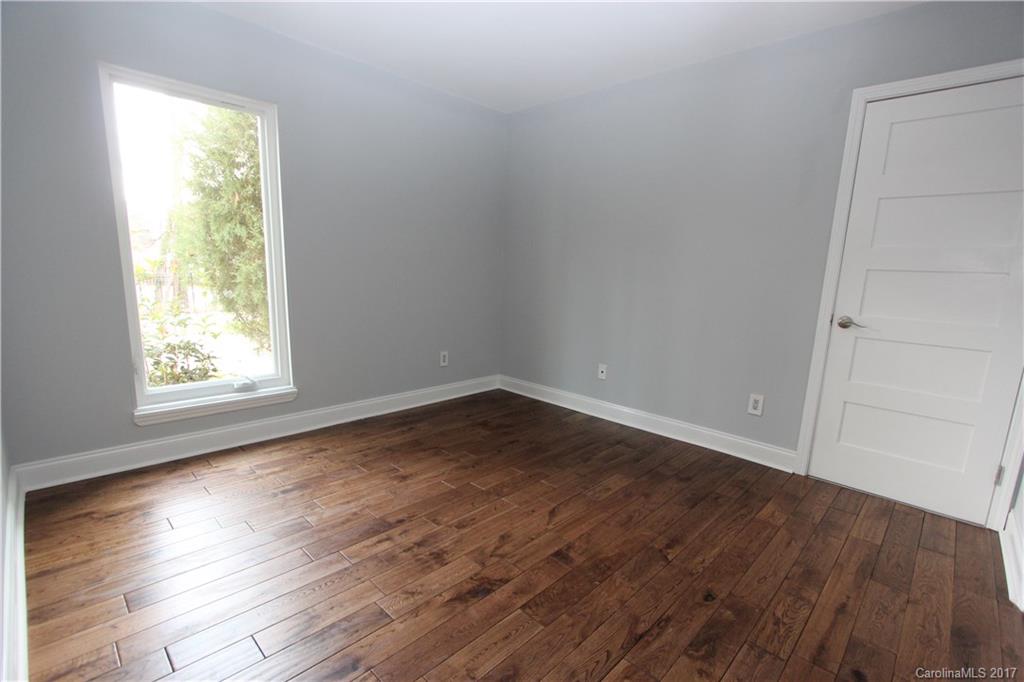 101 Heathwood Road Charlotte, NC 28211 - Photo 19 of 24 an empty room with wooden floor and windows