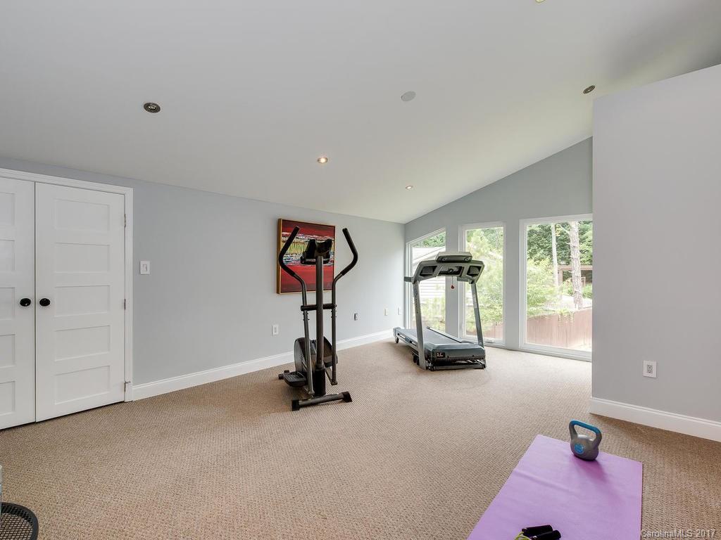 101 Heathwood Road Charlotte, NC 28211 - Photo 20 of 24 a room with gym equipment and a mirror