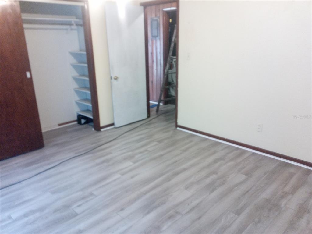 2822 South Dean Road Orlando, FL 32825 - Photo 14 of 43 an empty room with wooden floor and closet