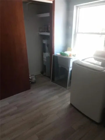 a room with a window and washer