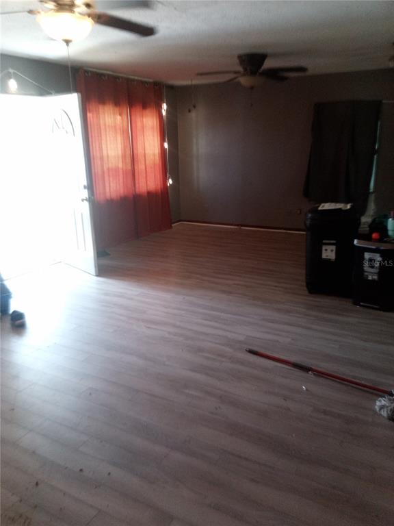 2822 South Dean Road Orlando, FL 32825 - Photo 20 of 43 an empty room with wooden floor and windows