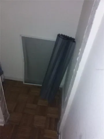 a view of small space with wooden floor and a window