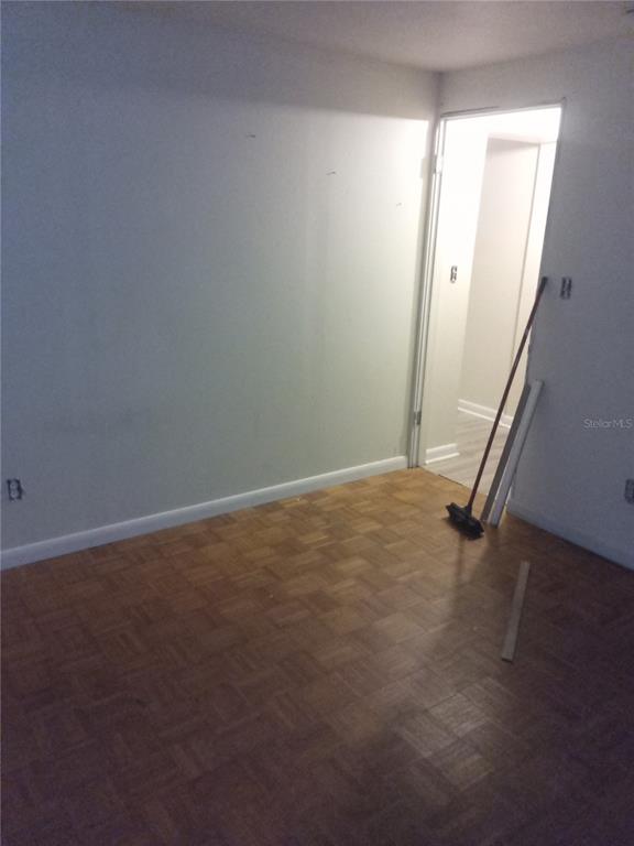 2822 South Dean Road Orlando, FL 32825 - Photo 39 of 43 an empty room with wooden floor and mirror