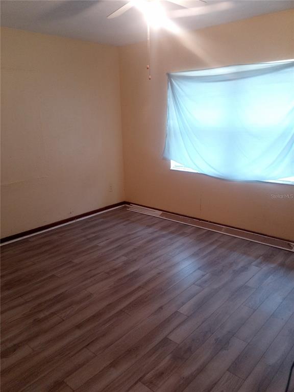 2822 South Dean Road Orlando, FL 32825 - Photo 40 of 43 a view of an empty room with wooden floor and a window