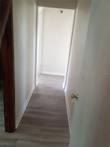 a view of a hallway with wooden floor