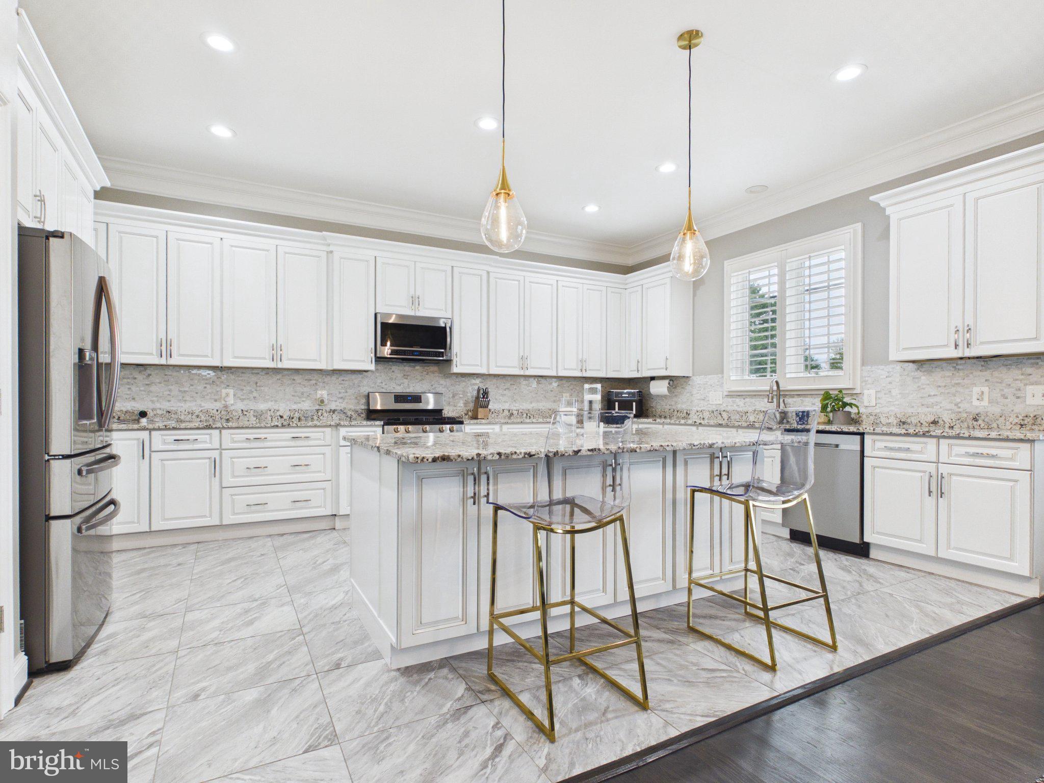38565 Piggott Bottom Road Hamilton, VA 20158 - Photo 13 of 85 a kitchen with stainless steel appliances granite countertop a stove a sink a refrigerator and white cabinets with wooden floor
