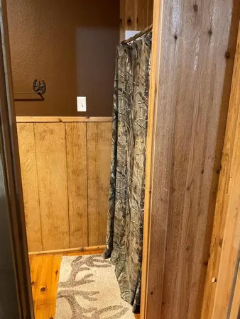a bathroom with a granite countertop shower and a sink