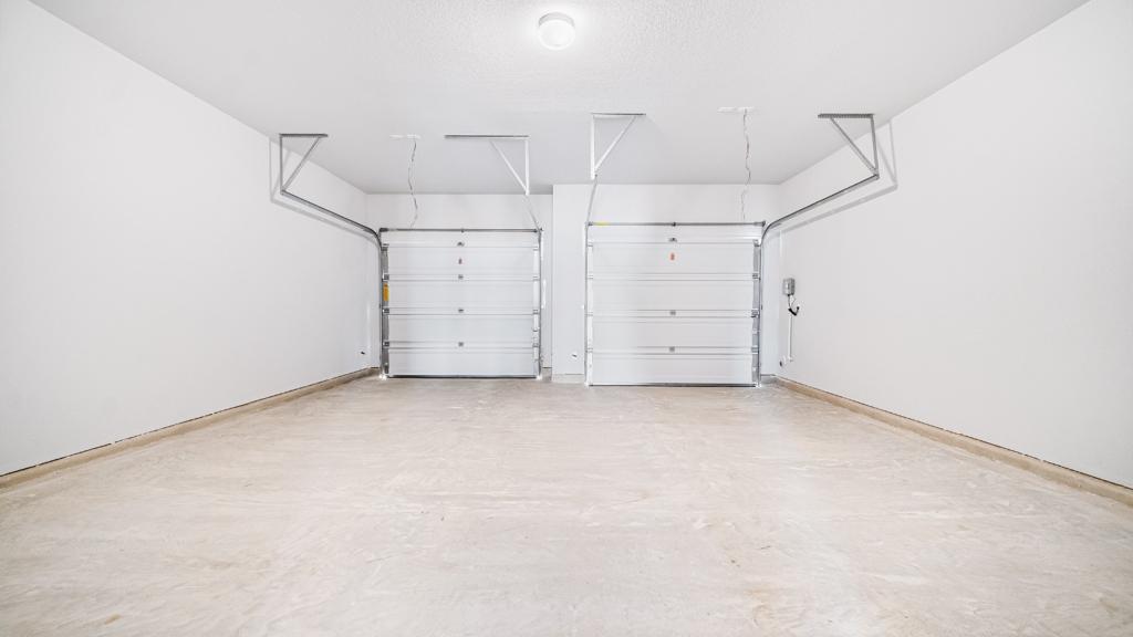 208 Stein Road Georgetown, TX 78626 - Photo 27 of 30 Garage featuring baseboards