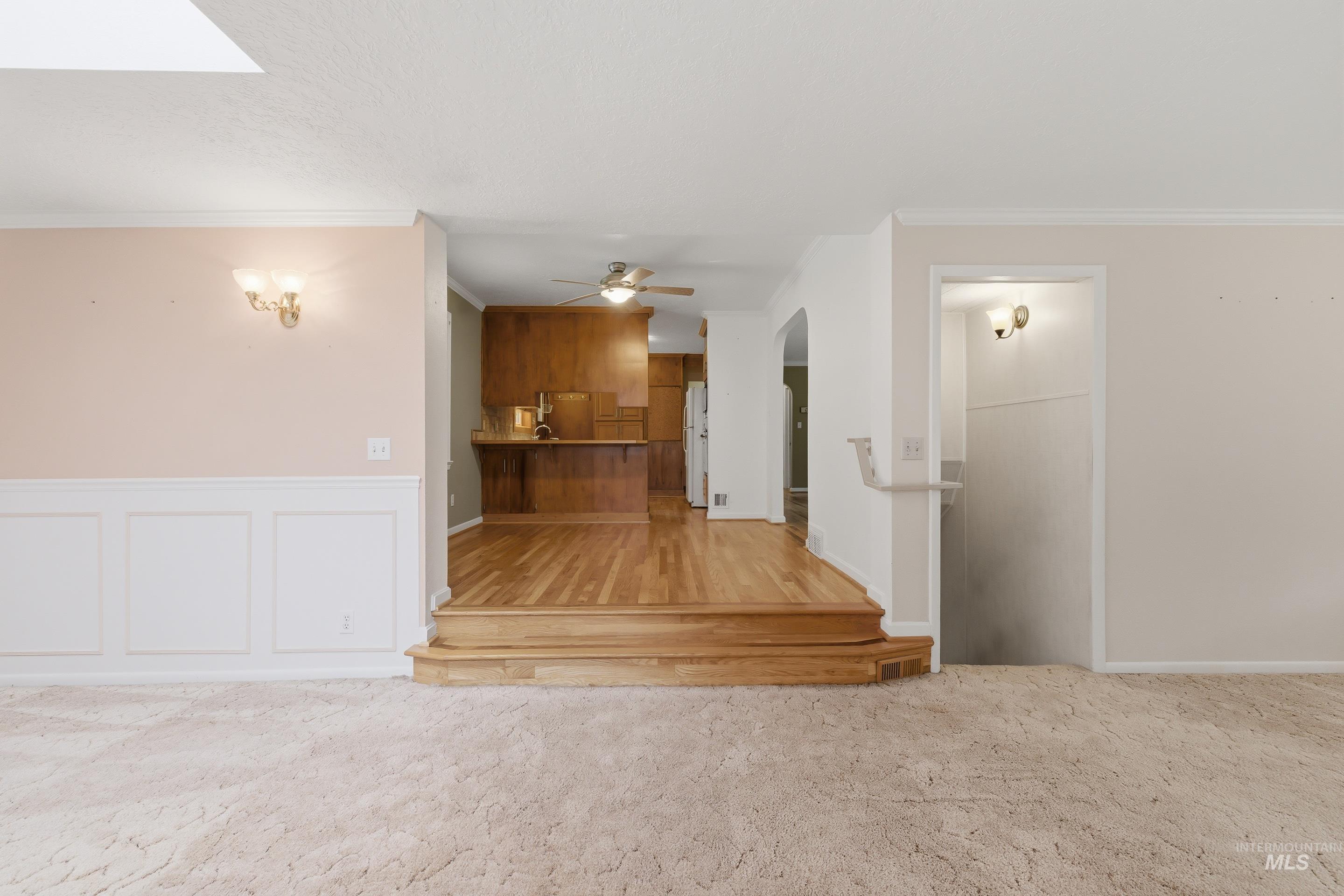 504 West Howe Street Boise, ID 83706 - Photo 13 of 47 Carpeted living area with wainscoting and wall sconces