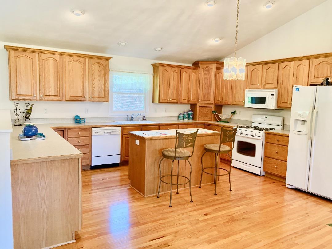 525 Mallard Point Road Wirtz, VA 24184 - Photo 11 of 38 a kitchen with stainless steel appliances granite countertop a table chairs sink refrigerator and cabinets