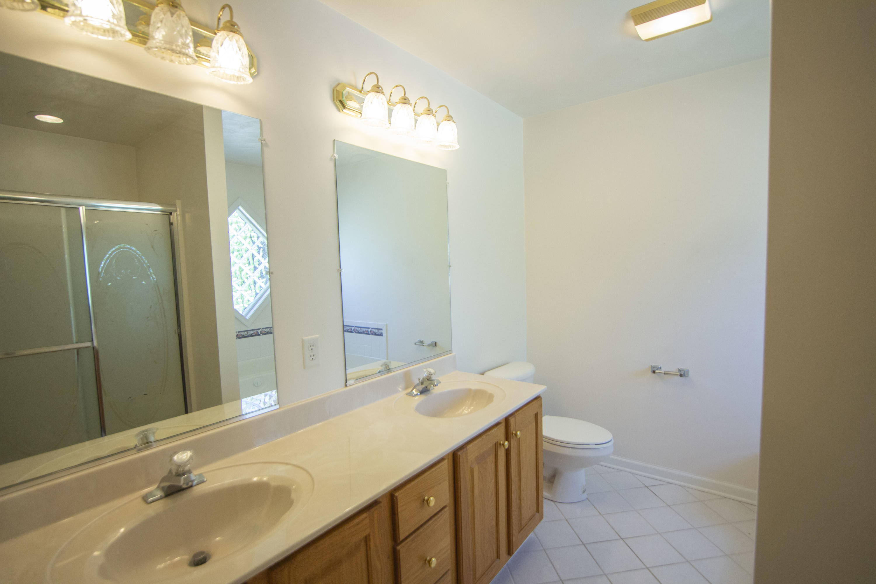 525 Mallard Point Road Wirtz, VA 24184 - Photo 19 of 38 a bathroom with a double vanity sink toilet and a mirror