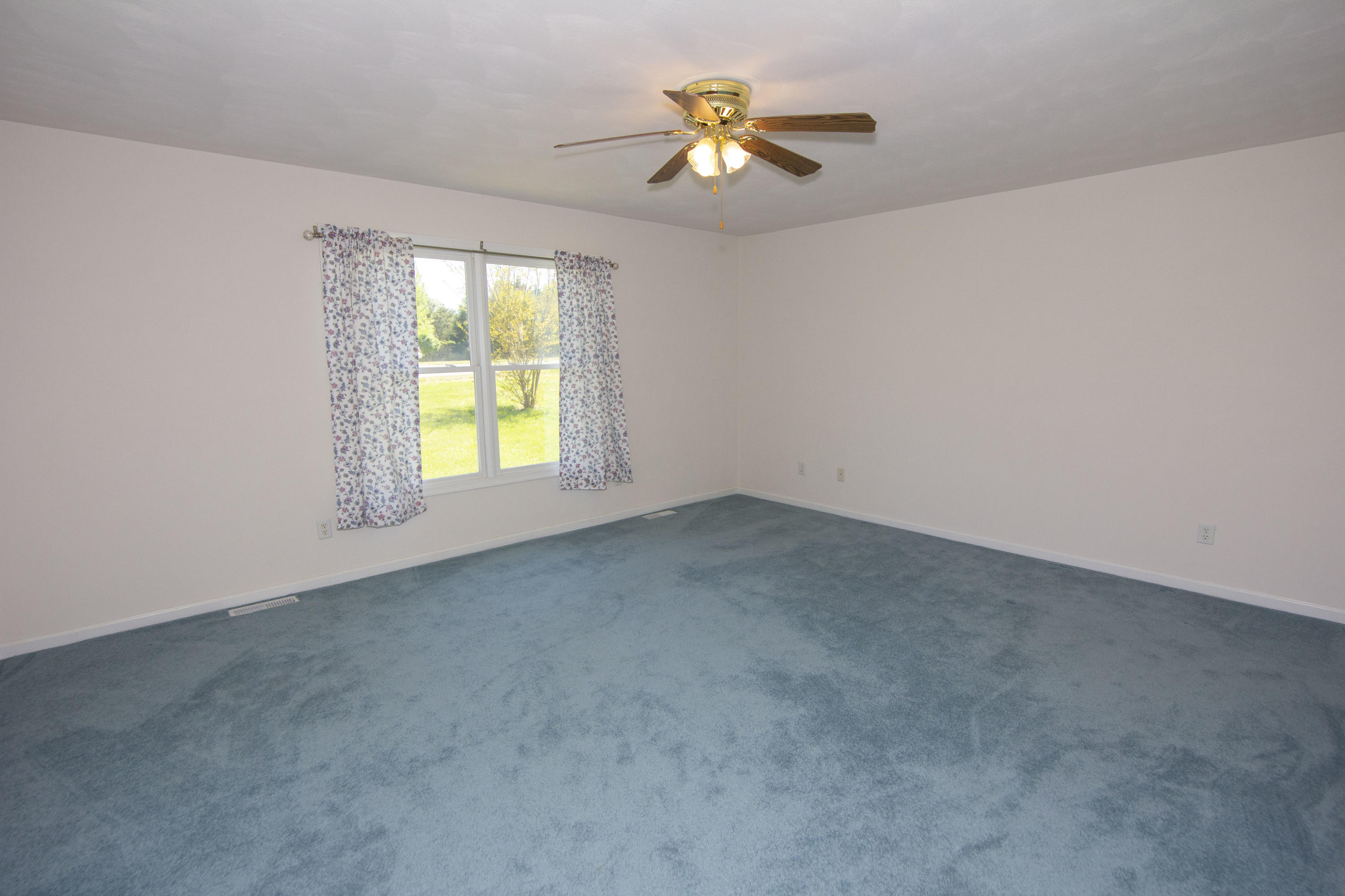 525 Mallard Point Road Wirtz, VA 24184 - Photo 26 of 38 an empty room with windows and chandelier fan
