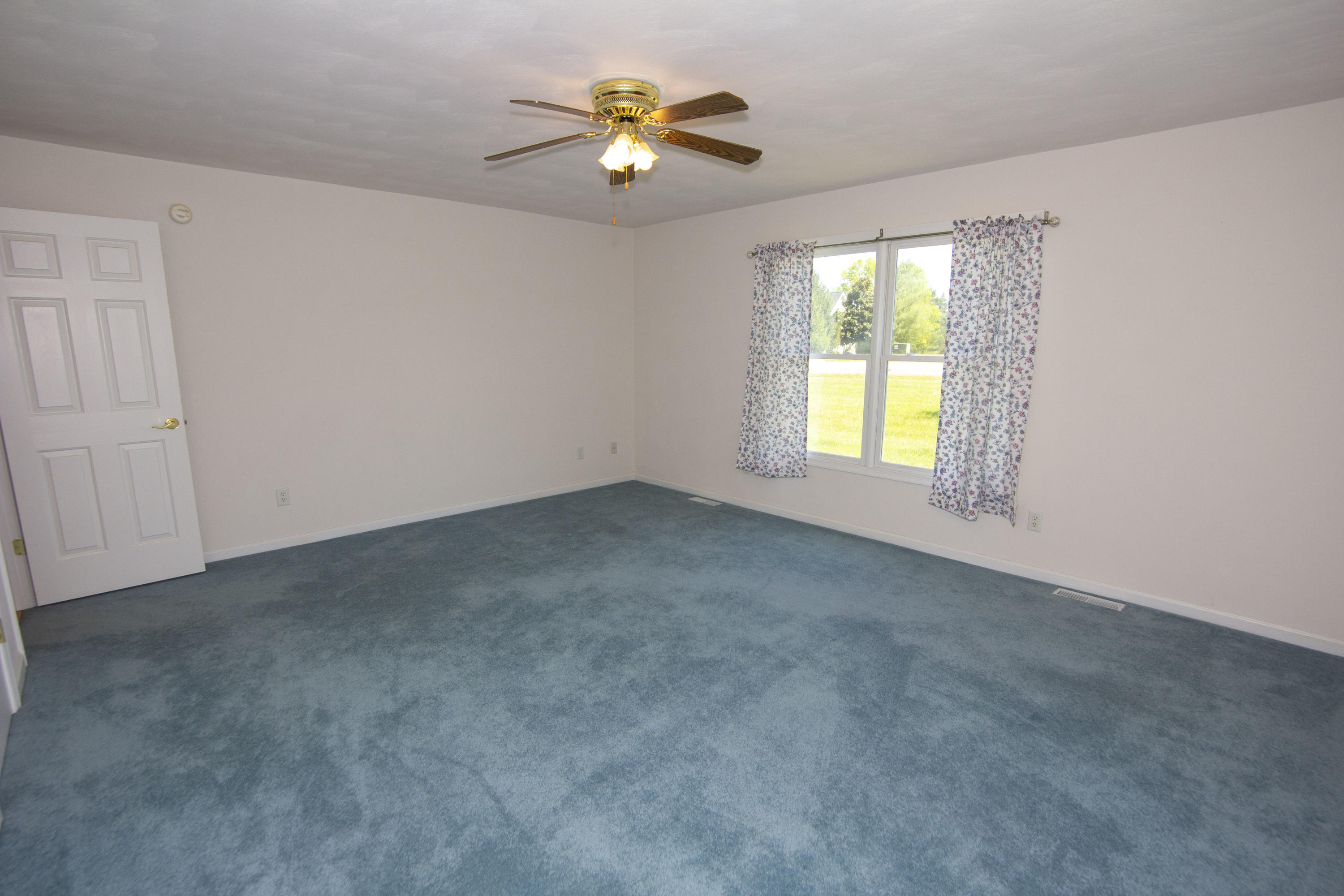 525 Mallard Point Road Wirtz, VA 24184 - Photo 29 of 38 an empty room with windows and chandelier fan