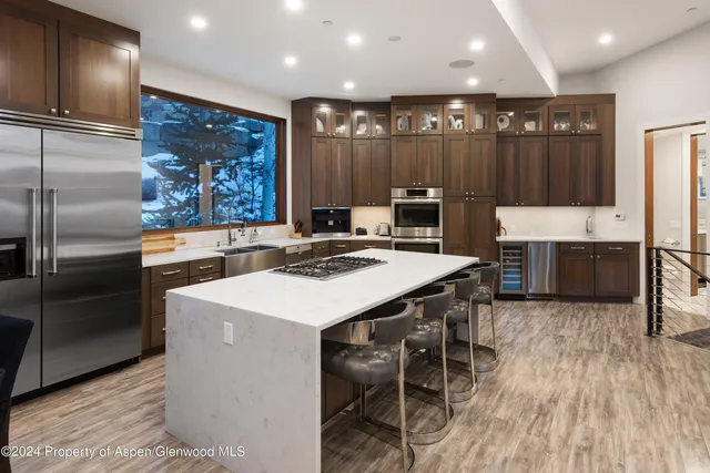 a kitchen with kitchen island a sink stainless steel appliances and cabinets