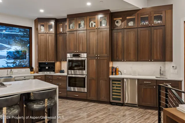 a kitchen with stainless steel appliances wooden cabinets and a stove top oven