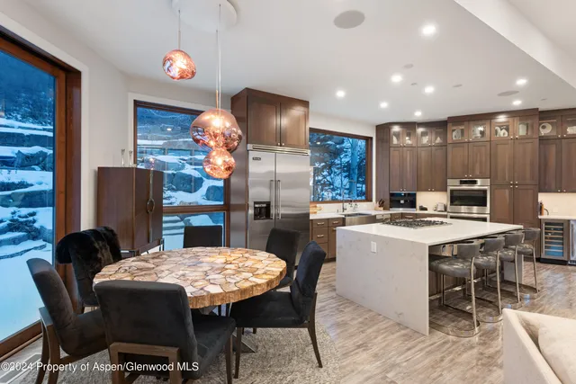a kitchen with a table and chairs in it