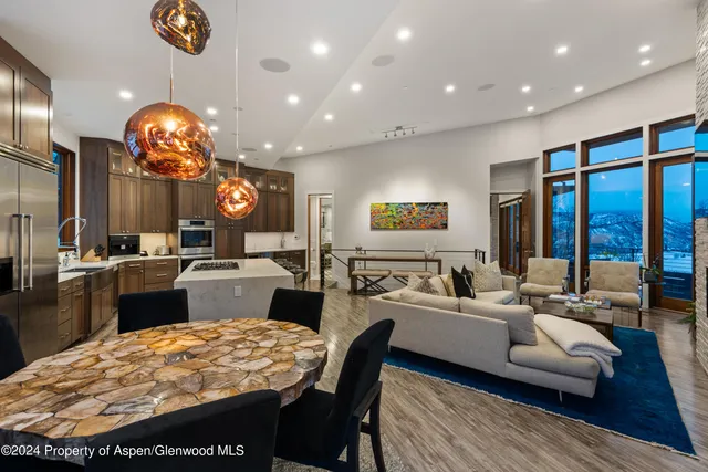 a large kitchen with a table and chairs
