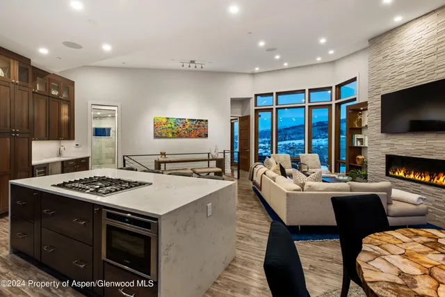 a living room with granite countertop furniture and a flat screen tv
