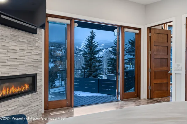 a view of a livingroom with a fireplace and wooden floor