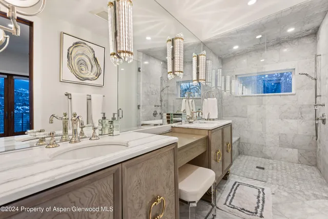 a bathroom with a sink a toilet a mirror and vanity