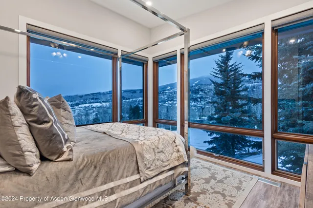 a bedroom with a large bed and a large window