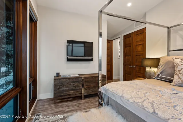 a bedroom with a bed and a flat screen tv