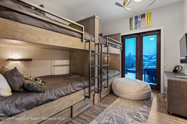 a bedroom with a large bed and a chandelier