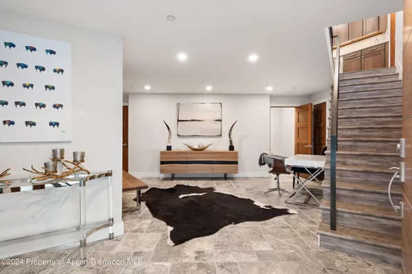 a view of an entryway with wooden floor