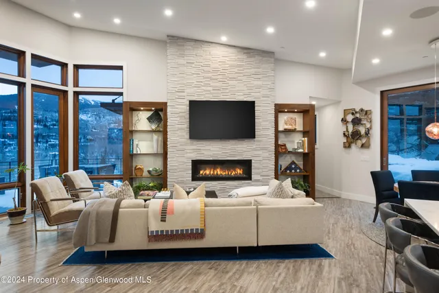 a living room with furniture wooden floor and a flat screen tv