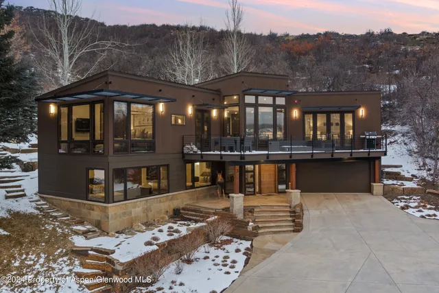 a view of a patio with couches and table with wooden floor and fence
